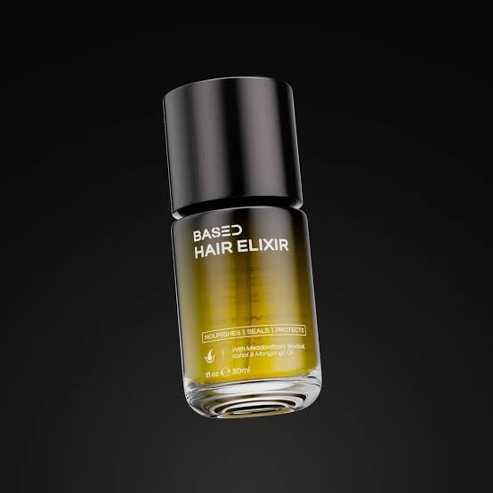Bottle of Based Bodyworks Hair Elixir with golden yellow oil and metallic silver cap on black background