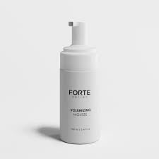 White FORTE volumizing shampoo bottle with pump dispenser on light background